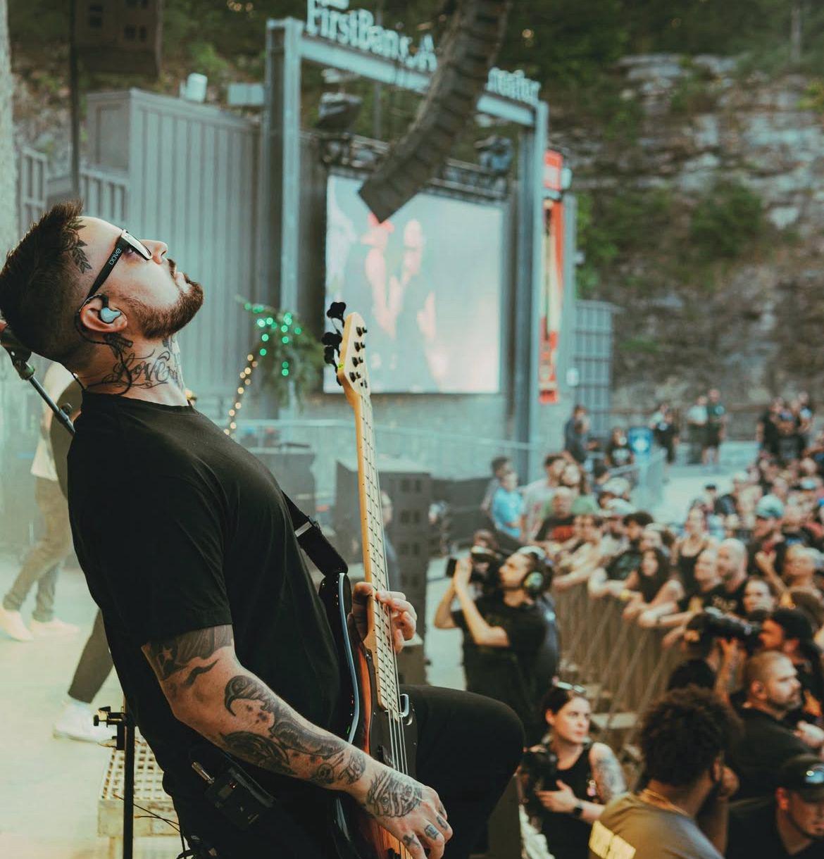 Merch drop - bass player on stage